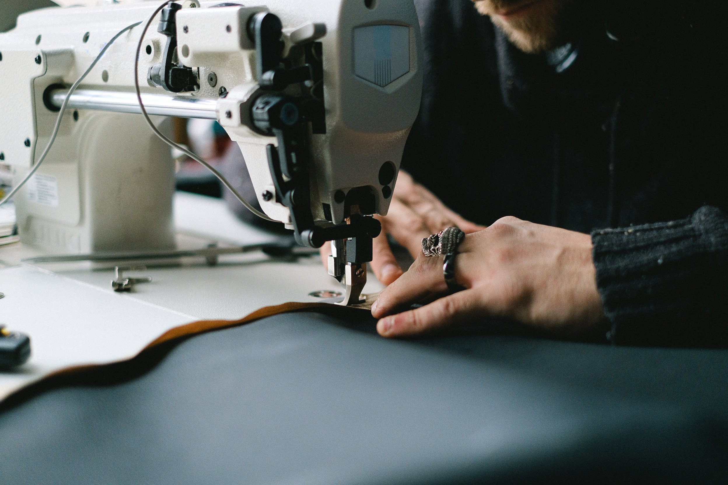 Close-up of Tailor Sewing on Machine